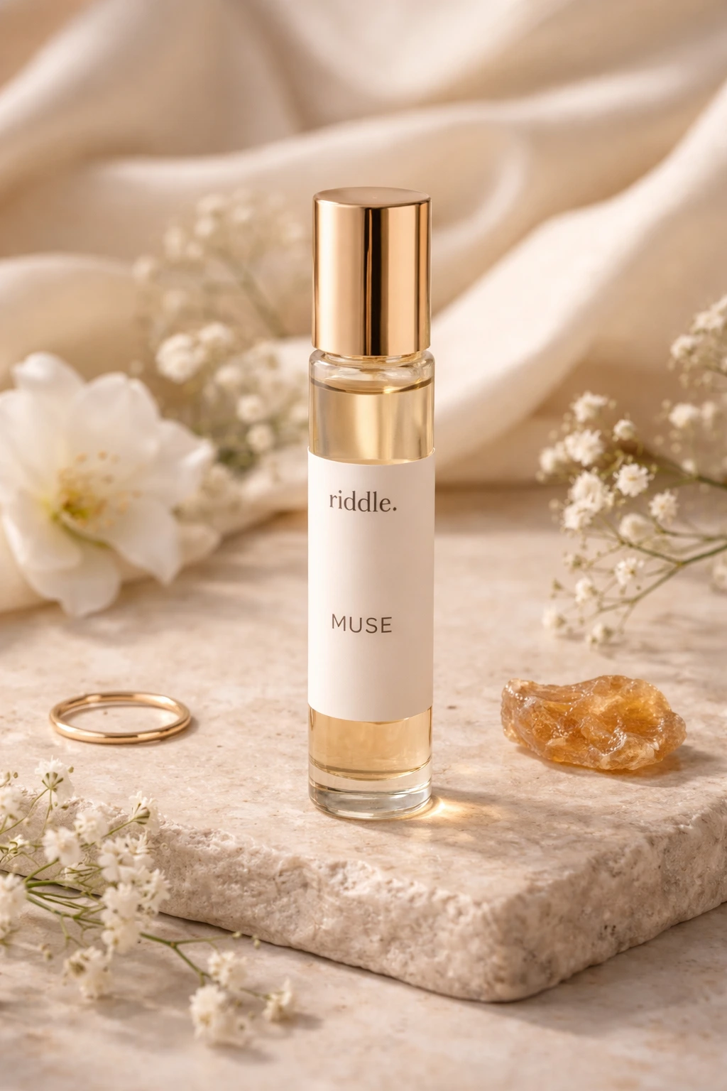 Riddle Muse perfume oil bottle on fabric